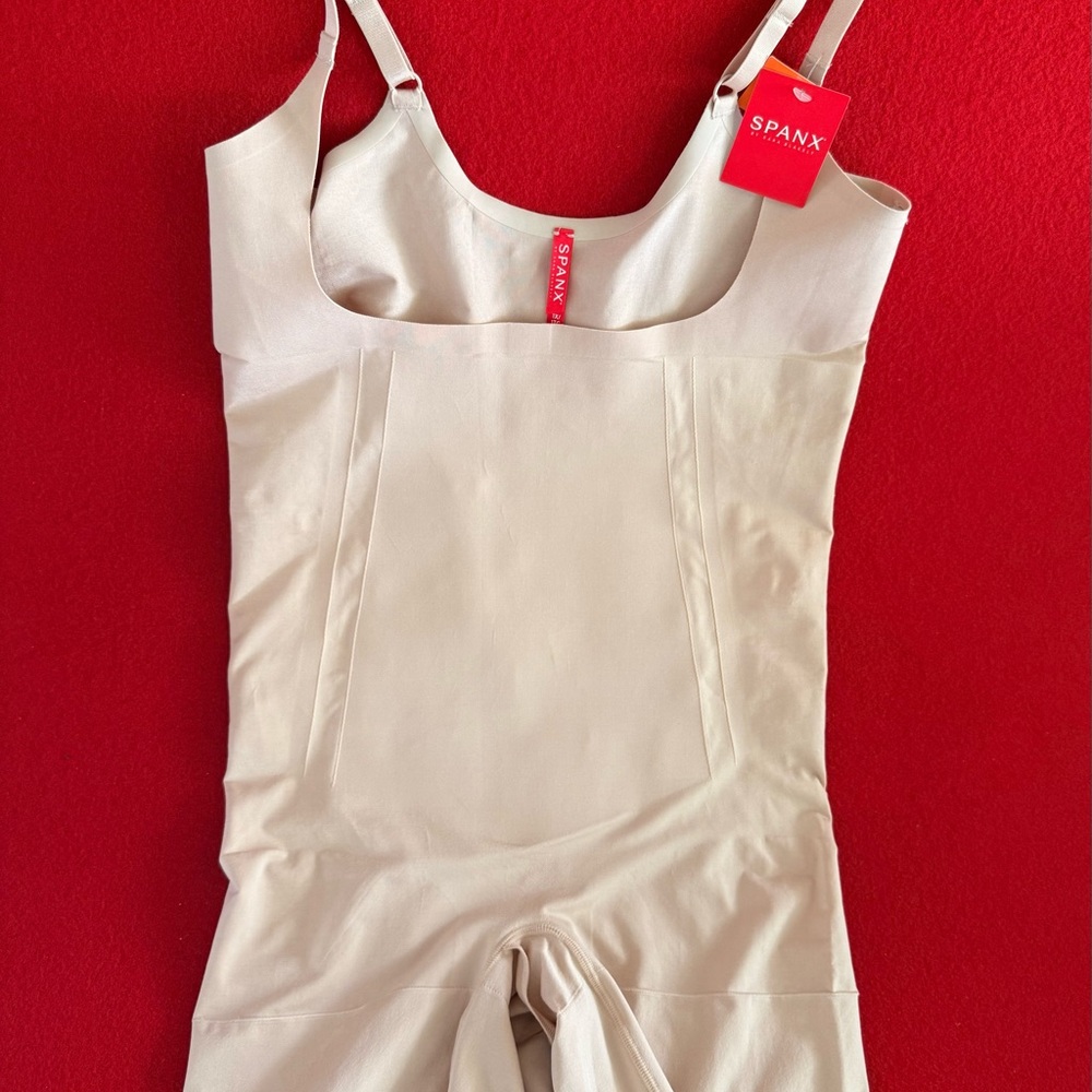 Spanx NWT Thinstincts Open-Bust Mid-Thigh Bodysuit in soft nude color.